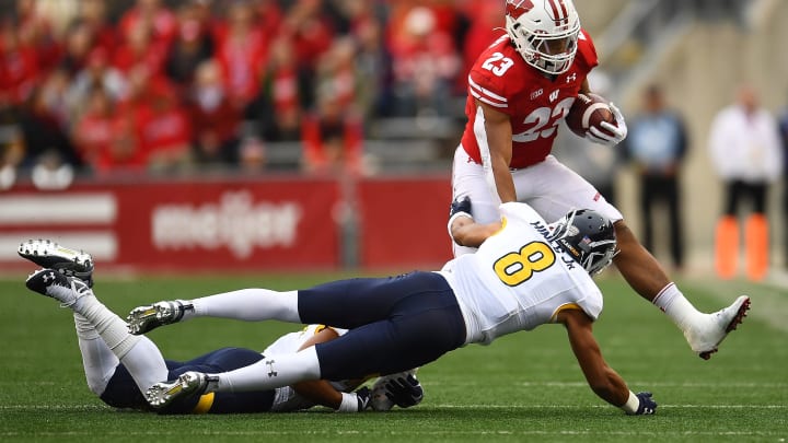 MADISON, WISCONSIN – OCTOBER 05: Jonathan Taylor #23 of the Wisconsin Badgers is pursued by Elvis Hines #8 of the Kent State Golden Flashes during the first half at Camp Randall Stadium on October 05, 2019 in Madison, Wisconsin. (Photo by Stacy Revere/Getty Images)