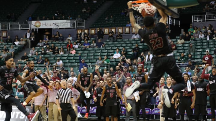 HONOLULU, HI - DECEMBER 23: The New Mexico State Aggies bench erupts as Zach Lofton