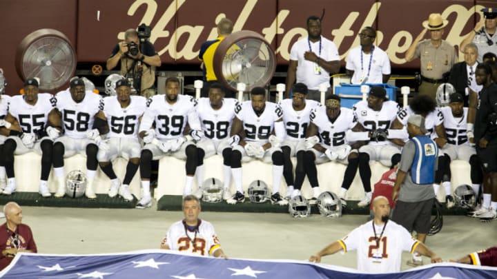 LANDOVER, MD - SEPTEMBER 24: Oakland Raiders players sit during the national anthem before they take on the Washington Redskins at FedExField on September 24, 2017 in Landover, Maryland. (Photo by Tasos Katopodis/Getty Images)