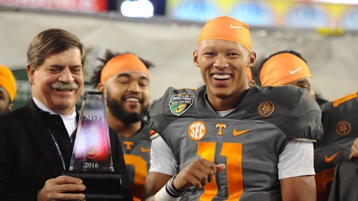 Dec 30, 2016; Nashville , TN, USA; Tennessee Volunteers quarterback Joshua Dobbs (11) is awarded the Music City Bowl MVP trophy after a win over the Nebraska Cornhuskers at Nissan Stadium. Tennessee won 38-24.Mandatory Credit: Christopher Hanewinckel-USA TODAY Sports