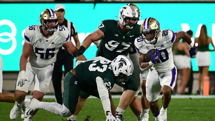 Sep 16, 2023; East Lansing, Michigan, USA; Washington Huskies running back Tybo Rogers (20) runs upfield against the Michigan State Spartans in the third quarter at Spartan Stadium. Mandatory Credit: Dale Young-USA TODAY Sports