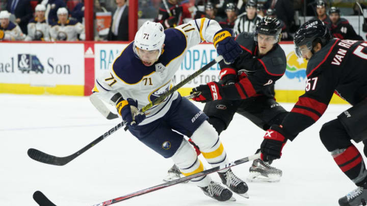 RALEIGH, NC - JANUARY 11: Carolina Hurricanes Defenceman Trevor van Riemsdyk (57) and Carolina Hurricanes Right Wing Saku Maenalanen (8) defends Buffalo Sabres Winger Evan Rodrigues (71) during a game between the Carolina Hurricanes and the Buffalo Sabres at the PNC Arena in Raleigh, NC on January 11, 2019. (Photo by Greg Thompson/Icon Sportswire via Getty Images)