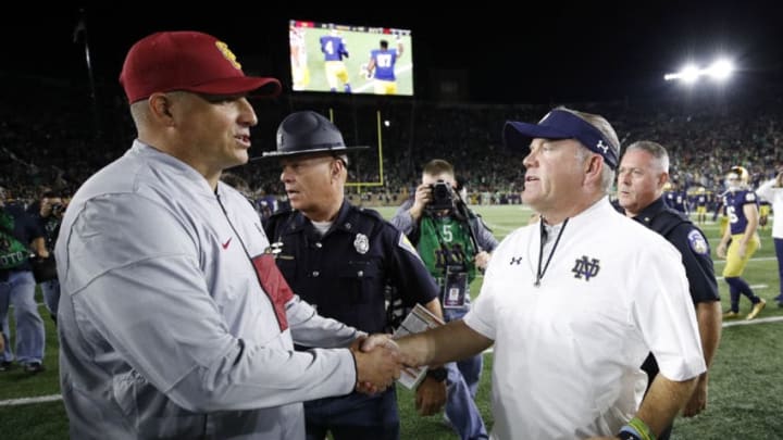 SOUTH BEND, IN - OCTOBER 21: Head coach Brian Kelly of the Notre Dame Fighting Irish shakes hands with head coach Clay Helton of the USC Trojans after a game at Notre Dame Stadium on October 21, 2017 in South Bend, Indiana. Notre Dame won 49-14. (Photo by Joe Robbins/Getty Images)