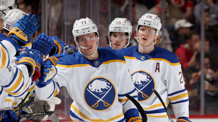 NEWARK, NEW JERSEY - APRIL 21: Victor Olofsson #71 of the Buffalo Sabres celebrates a teammate's goal with teammates on the bench during the second period against the New Jersey Devils at Prudential Center on April 21, 2022 in Newark, New Jersey. (Photo by Elsa/Getty Images)