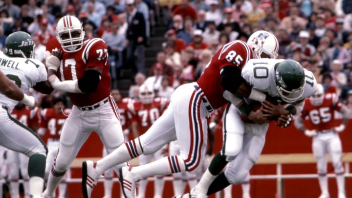 Oct 28, 1984; Foxboro, MA, USA; FILE PHOTO; New York Jets quarterback Pat Ryan (10) is tackled by New England Patriots defensive end Julius Adams (85) at Foxboro Stadium. Mandatory Credit: Dick Raphael-USA TODAY Sports