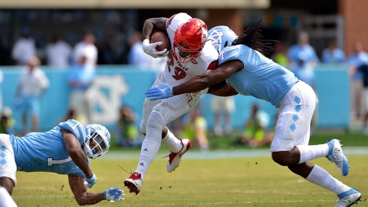 CHAPEL HILL, NC – SEPTEMBER 09: Myles Dorn #1 and Jonathan Smith #7 of the North Carolina Tar Heels tackle Malik Williams #29 of the Louisville Cardinals during the game at Kenan Stadium on September 9, 2017 in Chapel Hill, North Carolina. Louisville won 47-35. (Photo by Grant Halverson/Getty Images)