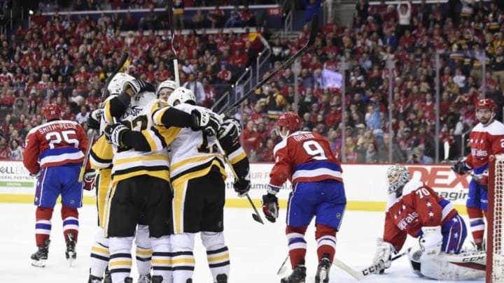 WASHINGTON, DC - DECEMBER 19: Bryan Rust #17 of the Pittsburgh Penguins celebrates with his teammates after scoring a goal in the second period against the Washington Capitals at Capital One Arena on December 19, 2018 in Washington, DC. (Photo by Patrick McDermott/NHLI via Getty Images)