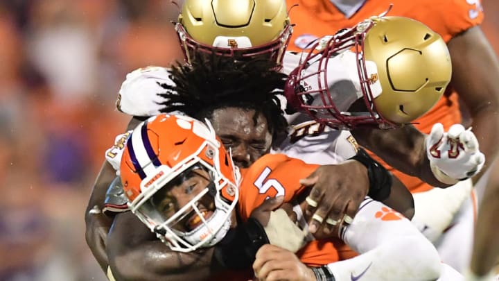 Oct 2, 2021; Clemson, South Carolina, USA; Clemson Tigers quarterback D.J. Uiagalelei (5) is tackled by Boston College Eagles defensive tackle Cam Horsley (96) during the second quarter at Memorial Stadium. Mandatory Credit: Adam Hagy-USA TODAY Sports