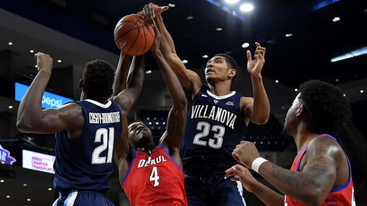 CHICAGO, ILLINOIS – JANUARY 30: Paul Reed #4 of the DePaul Blue Demons battles Dhamir Cosby-Roundtree #21 of the Villanova Wildcats and Jermaine Samuels #23 of the Villanova Wildcats (Photo by Quinn Harris/Getty Images)