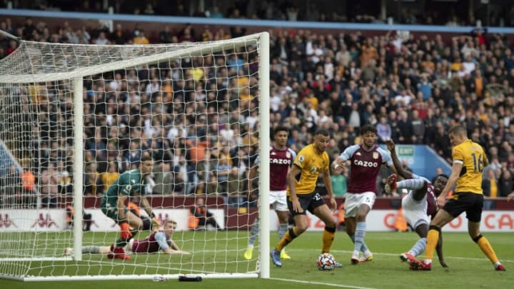 BIRMINGHAM, ENGLAND – OCTOBER 16: Conor Coady (r) of Wolverhampton Wanderers scores a goal from close range to make the score 2-2 during the Premier League match between Aston Villa and Wolverhampton Wanderers at Villa Park on October 16, 2021 in Birmingham, England. (Photo by Malcolm Couzens/Getty Images)