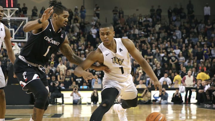 ORLANDO, FL - JANUARY 16: B.J. Taylor #1 of the UCF Knights dribbles past Jacob Evans #1 of the Cincinnati Bearcats during a NCAA basketball game at the CFE Arena on January 16, 2018 in Orlando, Florida. (Photo by Alex Menendez/Getty Images)