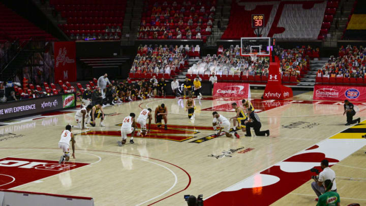 Jan 7, 2021; College Park, Maryland, USA; Maryland Terrapins and Iowa Hawkeyes take a knee together before the game at Xfinity Center. Mandatory Credit: Tommy Gilligan-USA TODAY Sports