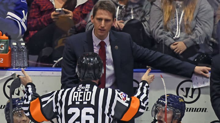 MISSISSAUGA, ON - NOVEMBER 27: Coach Kris Knoblauch of the Erie Otters gets an explanation of a call for the referee during OHL game action on November 27, 2015 at the Hershey Centre in Mississauga, Ontario, Canada. (Photo by Graig Abel/Getty Images)
