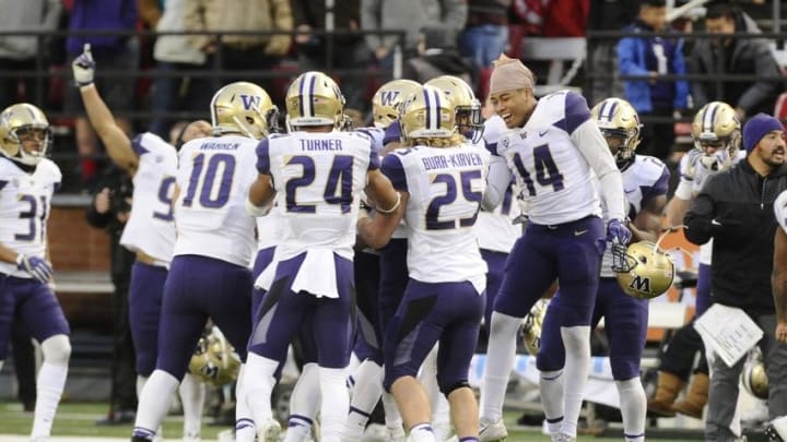 Nov 25, 2016; Pullman, WA, USA; Washington Huskies defense celebrates a interception against the Washington State Cougars during the second half at Martin Stadium. The Huskies won 45-17. Mandatory Credit: James Snook-USA TODAY Sports