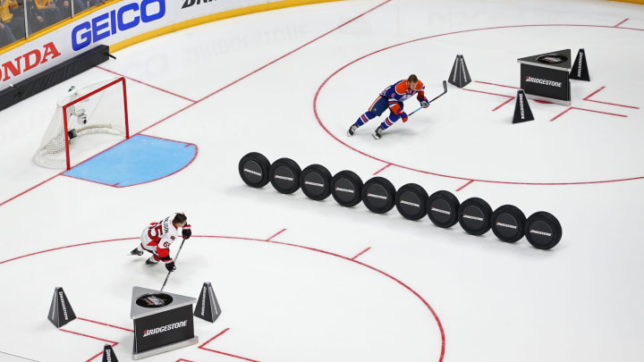 Jan 30, 2016; Nashville, TN, USA; Atlantic Division defenseman Erik Karlsson (bottom) of the Ottawa Senators skates against Pacific Division forward Taylor Hall (top) of the Edmonton Oilers during the Fastest Skater Challenge during the 2016 NHL All Star Game Skills Competition at Bridgestone Arena. Mandatory Credit: Aaron Doster-USA TODAY Sports