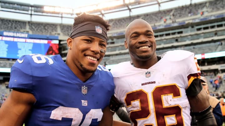 EAST RUTHERFORD, NJ – OCTOBER 28: Saquon Barkley #26 of the New York Giants and Adrian Peterson #26 of the Washington Redskins pose for a picture after the game on October 28,2018 at MetLife Stadium in East Rutherford, New Jersey. (Photo by Elsa/Getty Images)