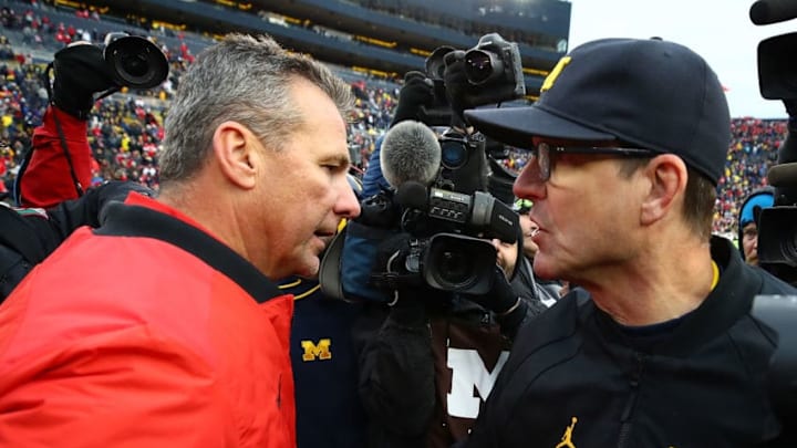 ANN ARBOR, MI - NOVEMBER 25: Urban Meyer head coach of the Ohio State Buckeyes and Jim Harbaugh head coach of the Michigan Wolverines shake hands after the game. Ohio State won 31 to 20 on November 25, 2017 at Michigan Stadium in Ann Arbor, Michigan. (Photo by Gregory Shamus/Getty Images)