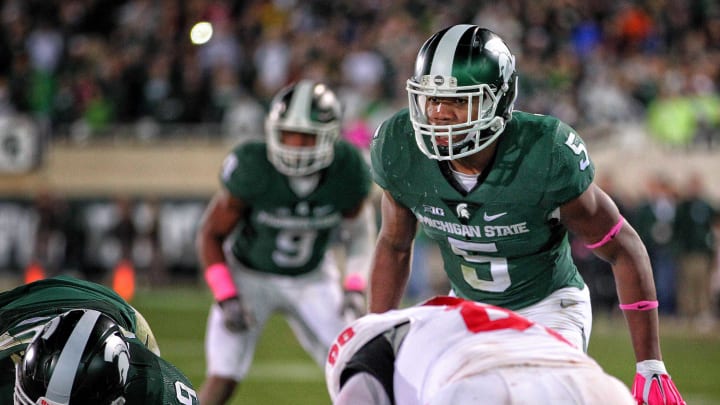 Oct 24, 2015; East Lansing, MI, USA; Michigan State Spartans linebacker Andrew Dowell (5) looks over the Indiana Hoosiers offensive during the 1st half of a game at Spartan Stadium. Mandatory Credit: Mike Carter-USA TODAY Sports