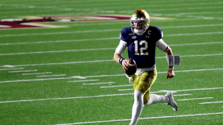 CHESTNUT HILL, MASSACHUSETTS - NOVEMBER 14: Ian Book #12 of the Notre Dame Fighting Irish runs the ball in for a touchdown against the Boston College Eagles during the second half at Alumni Stadium on November 14, 2020 in Chestnut Hill, Massachusetts. (Photo by Maddie Meyer/Getty Images)