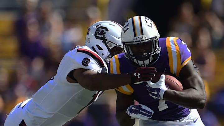 Leonard Fournette #7 of the LSU Tigers is pursued by Jonathan Walton #28 of the South Carolina Gamecocks. (Photo by Stacy Revere/Getty Images)