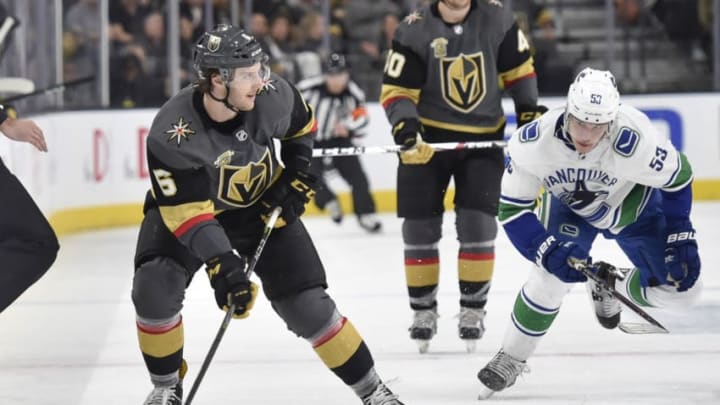 LAS VEGAS, NV - FEBRUARY 23: Colin Miller #6 of the Vegas Golden Knights skates with the puck while Bo Horvat #53 of the Vancouver Canucks defends during the game at T-Mobile Arena on February 23, 2018 in Las Vegas, Nevada. (Photo by David Becker/NHLI via Getty Images)