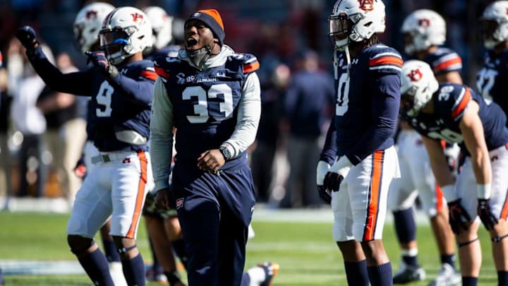 Auburn linebacker K.J. Britt (33) helps with warm ups at Jordan-Hare Stadium in Auburn, Ala., on Saturday, Dec. 5, 2020. Texas A&M defeated Auburn 31-20.