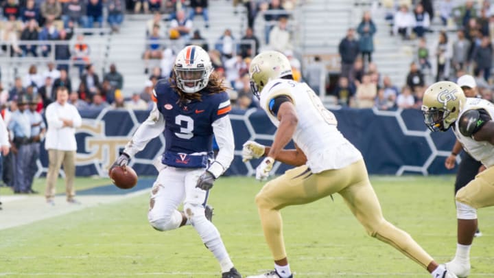 ATLANTA, GA - NOVEMBER 17: Quarterback Bryce Perkins #3 of the Virginia Cavaliers looks to maneuver by defensive back Lamont Simmons #6 of the Georgia Tech Yellow Jackets during the second quarter at Bobby Dodd Stadium on November 17, 2018 in Atlanta, Georgia. (Photo by Michael Chang/Getty Images)