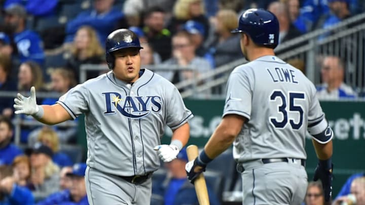 KANSAS CITY, MISSOURI - APRIL 29: Ji-Man Choi #26 celebrates with Nate Lowe #35 of the Tampa Bay Rays after scoring on a Yandy Diaz single in the first inning against the Kansas City Royals at Kauffman Stadium on April 29, 2019 in Kansas City, Missouri. (Photo by Ed Zurga/Getty Images)