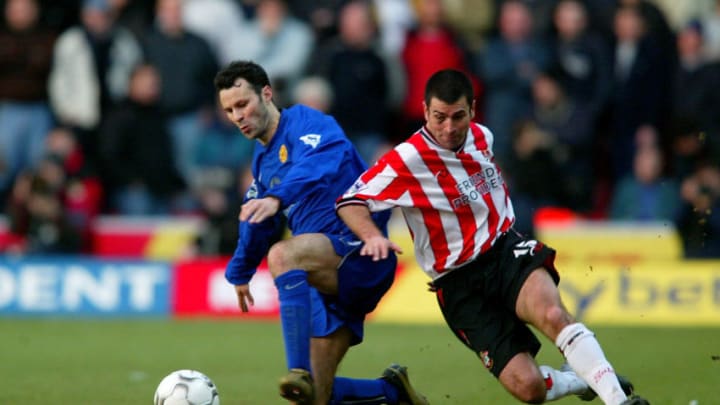 SOUTHAMPTON - FEBRUARY 1: Ryan Giggs of Manchester United is challenged by Francis Benali of Southampton during the FA Barclaycard Premiership match between Southampton and Manchester United at St Mary's Stadium in Southampton, England on February 1, 2003. (Photo by Phil Cole/Getty Images)