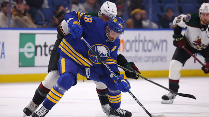 Nov 8, 2022; Buffalo, New York, USA; Buffalo Sabres left wing Zemgus Girgensons (28) looks to control the puck as Arizona Coyotes left wing Lawson Crouse (67) defends during the third period at KeyBank Center. Mandatory Credit: Timothy T. Ludwig-USA TODAY Sports