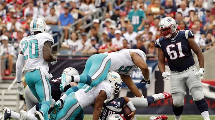 Sep 18, 2016; Foxborough, MA, USA; New England Patriots quarterback Jimmy Garoppolo (10) is sacked by Miami Dolphins defensive end Cameron Wake (91) in the second quarter at Gillette Stadium. Mandatory Credit: David Butler II-USA TODAY Sports