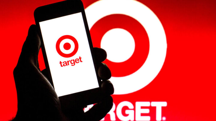 SPAIN - 2021/11/16: In this photo illustration, a Target Corporation logo is seen on a smartphone screen with a Target Corporation logo in the background. (Photo Illustration by Thiago Prudencio/SOPA Images/LightRocket via Getty Images)