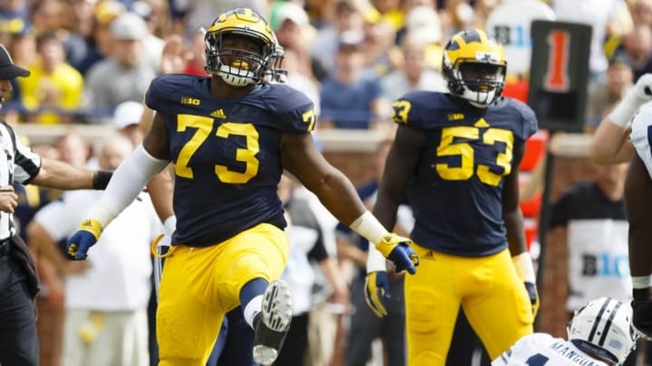 Sep 26, 2015; Ann Arbor, MI, USA; Michigan Wolverines defensive tackle Maurice Hurst (73) celebrates a sack of Brigham Young Cougars quarterback Tanner Mangum (12) in the second quarter at Michigan Stadium. Mandatory Credit: Rick Osentoski-USA TODAY Sports