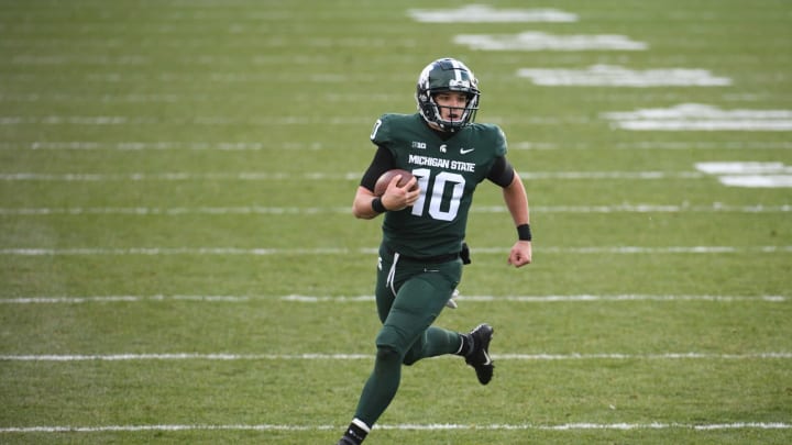 Dec 5, 2020; East Lansing, Michigan, USA; Michigan State Spartans quarterback Payton Thorne (10) runs the ball during the fourth quarter against the Ohio State Buckeyes at Spartan Stadium. Mandatory Credit: Tim Fuller-USA TODAY Sports