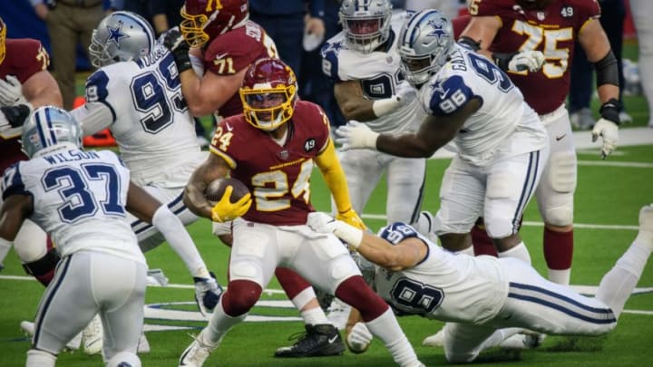 Nov 26, 2020; Arlington, Texas, USA; Washington Football Team running back Antonio Gibson (24) runs for a first down against the Dallas Cowboys during the first quarter at AT&T Stadium. Mandatory Credit: Jerome Miron-USA TODAY Sports Nov 26, 2020; Arlington, Texas, USA; Washington Football Team running back Antonio Gibson (24) runs for a first down against the Dallas Cowboys during the first quarter at AT&T Stadium. Mandatory Credit: Jerome Miron-USA TODAY Sports
