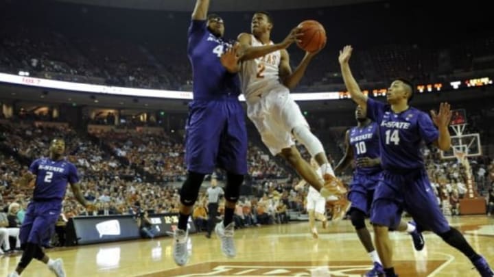 Mar 7, 2015; Austin, TX, USA; Texas Longhorns guard Demarcus Holland (2) shoots against Kansas State Wildcats guard Justin Edwards (14) and forward Stephen Hurt (41) during the first half at the Frank Erwin Special Events Center. Mandatory Credit: Brendan Maloney-USA TODAY Sports