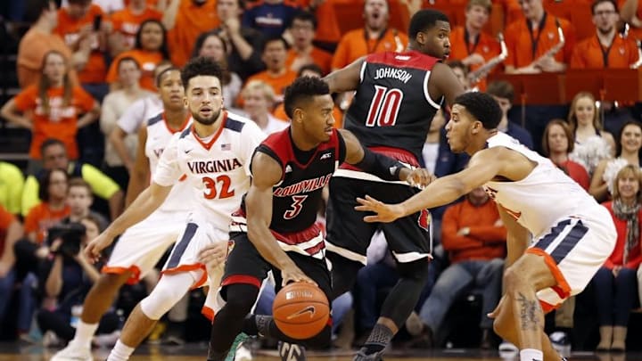 Mar 5, 2016; Charlottesville, VA, USA; Louisville Cardinals guard Trey Lewis (3) dribbles the ball as Virginia Cavaliers forward Isaiah Wilkins (21) defends in the second half at John Paul Jones Arena. The Cavaliers won 68-46. Mandatory Credit: Geoff Burke-USA TODAY Sports