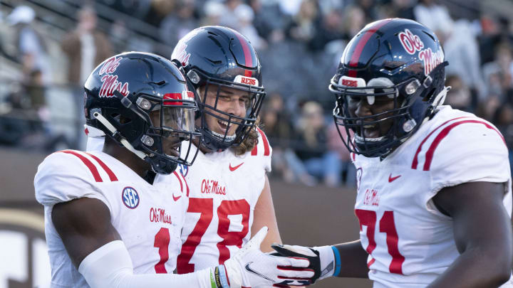 Oct 8, 2022; Nashville, Tennessee, USA; Mississippi Rebels wide receiver Jonathan Mingo (1) celebrates withy teammates Jeremy James (78) and Jayden Williams (71) after a 71 yard touchdown catch against the Vanderbilt Commodores during the third quarter at FirstBank Stadium. Mandatory Credit: George Walker IV – USA TODAY Sports