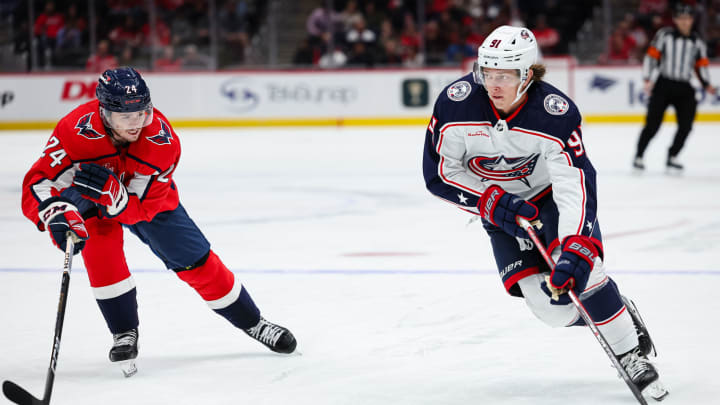 WASHINGTON, DC – OCTOBER 07: Kent Johnson #91 of the Columbus Blue Jackets skates with the puck against Connor McMichael #24 of the Washington Capitals during the first period of the NHL preseason game at Capital One Arena on October 7, 2023 in Washington, DC. (Photo by Scott Taetsch/Getty Images)