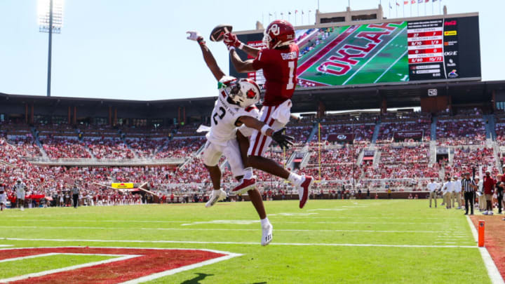 Sep 2, 2023; Norman, Oklahoma, USA; Oklahoma Sooners wide receiver Jayden Gibson (1) makes a leaping touchdown catch over Arkansas State Red Wolves cornerback Leon Jones (2) during the third quarter at Gaylord Family-Oklahoma Memorial Stadium. Mandatory Credit: Kevin Jairaj-USA TODAY Sports