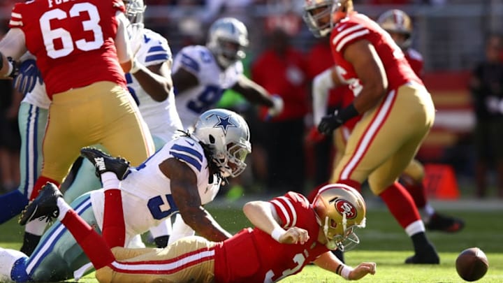 SANTA CLARA, CA - OCTOBER 22: Jaylon Smith #54 of the Dallas Cowboys strips the ball from C.J. Beathard #3 of the San Francisco 49ers during their NFL game at Levi's Stadium on October 22, 2017 in Santa Clara, California. (Photo by Ezra Shaw/Getty Images)