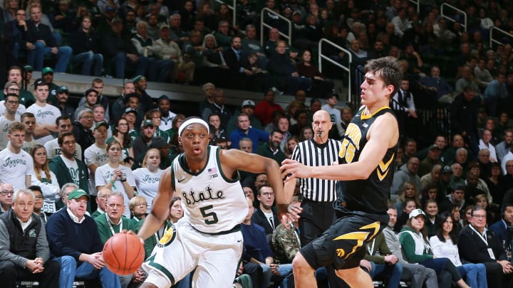 EAST LANSING, MI – DECEMBER 03: Cassius Winston #5 of the Michigan State Spartans drives past Luka Garza #55 of the Iowa Hawkeyes in the first half at Breslin Center on December 3, 2018 in East Lansing, Michigan. (Photo by Rey Del Rio/Getty Images)