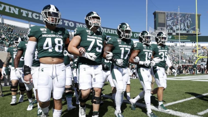 EAST LANSING, MI - SEPTEMBER 14: Michigan State Spartans players walk around the field with locked arms prior to the game against the Arizona State Sun Devils at Spartan Stadium on September 14, 2019 in East Lansing, Michigan. (Photo by Joe Robbins/Getty Images)