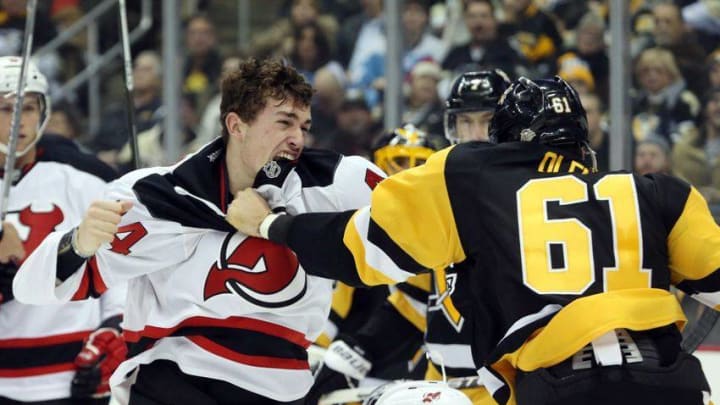 Dec 23, 2016; Pittsburgh, PA, USA; New Jersey Devils left wing Miles Wood (44) and Pittsburgh Penguins defenseman Steve Oleksy (61) fight during the second period at the PPG PAINTS Arena. Mandatory Credit: Charles LeClaire-USA TODAY Sports