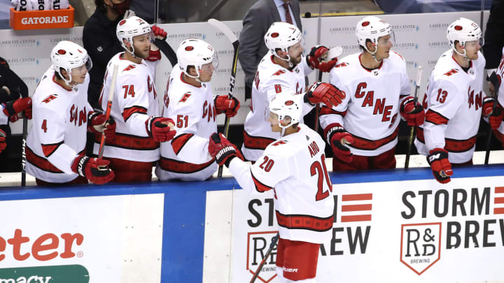 Sebastian Aho #20 of the Carolina Hurricanes is congratulated after he got the assist on a goal by teammate Teuvo Teravainen in the third period against the Washington Capitals.