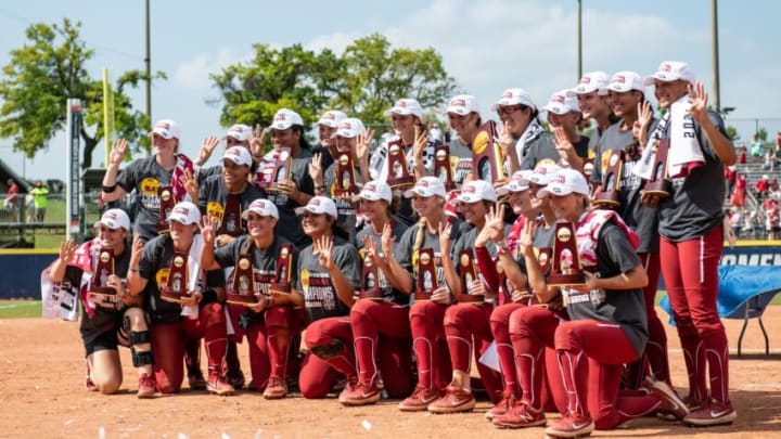 Jun 10, 2021; Oklahoma City, Oklahoma, USA; Oklahoma Sooners pose with the championship trophy after the game against the Florida State Seminoles during game three of the NCAA Womens College World Series Championship Series at USA Softball Hall of Fame Stadium. Mandatory Credit: Rob Ferguson-USA TODAY Sports
