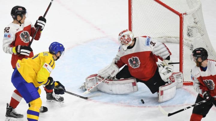 Austria's David Madlener (2R) vies with Sweden's Mikael Backlund (L) during the group A match Sweden vs Austria of the 2018 IIHF Ice Hockey World Championship in Copenhagen, Denmark, on May 9, 2018. (Photo by HELMUT FOHRINGER / APA / AFP) / Austria OUT / The erroneous mention[s] appearing in the metadata of this photo by HELMUT FOHRINGER has been modified in AFP systems in the following manner: ADDING RECTRICTION "AUSTRIA OUT". Please immediately remove the erroneous mention[s] from all your online services and delete it (them) from your servers. If you have been authorized by AFP to distribute it (them) to third parties, please ensure that the same actions are carried out by them. Failure to promptly comply with these instructions will entail liability on your part for any continued or post notification usage. Therefore we thank you very much for all your attention and prompt action. We are sorry for the inconvenience this notification may cause and remain at your disposal for any further information you may require. (Photo credit should read HELMUT FOHRINGER/AFP/Getty Images)