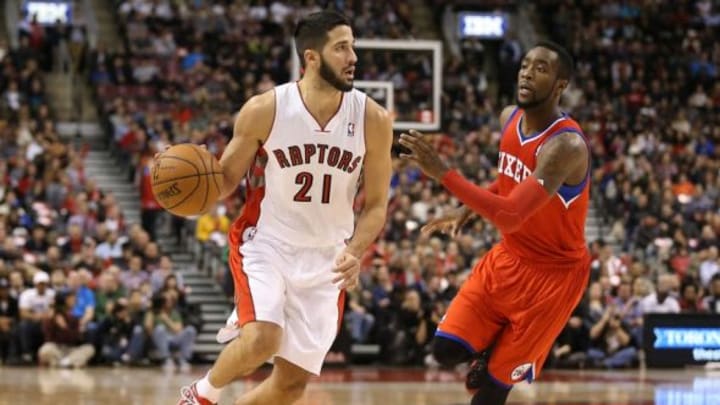 Dec 13, 2013; Toronto, Ontario, CAN; Toronto Raptors guard Greivis Vasquez (21) dribbles the ball against Philadelphia 76ers guard Tony Wroten (8) at Air Canada Centre. The Raptors beat the 76ers 108-100. Mandatory Credit: Tom Szczerbowski-USA TODAY Sports