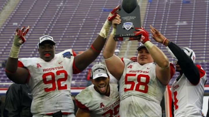 Jan 2, 2015; Fort Worth, TX, USA; Houston Cougars defensive tackle Joey Mbu (92), Kenneth Farrow (35) and Bryce Redman (58) with trophy following the 2015 Armed Forces Bowl against Pittsburgh Panthers at Amon G. Carter Stadium. Houston won 35-34. Mandatory Credit: Ray Carlin-USA TODAY Sports Jan 2, 2015; Fort Worth, TX, USA; Houston Cougars defensive tackle Joey Mbu (92), Kenneth Farrow (35) and Bryce Redman (58) with trophy following the 2015 Armed Forces Bowl against Pittsburgh Panthers at Amon G. Carter Stadium. Houston won 35-34. Mandatory Credit: Ray Carlin-USA TODAY Sports