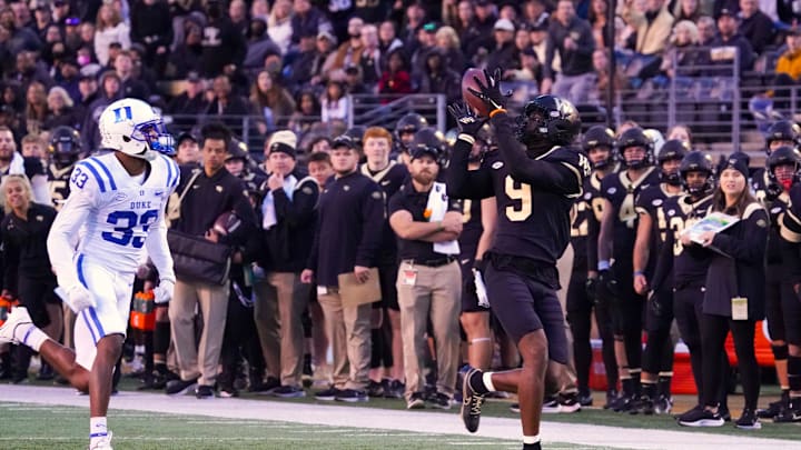 Oct 30, 2021; Winston-Salem, North Carolina, USA; Wake Forest Demon Deacons wide receiver A.T. Perry (9) makes a catch against Duke Blue Devils cornerback Leonard Johnson (33) during the second half at Truist Field. Mandatory Credit: James Guillory-USA TODAY Sports